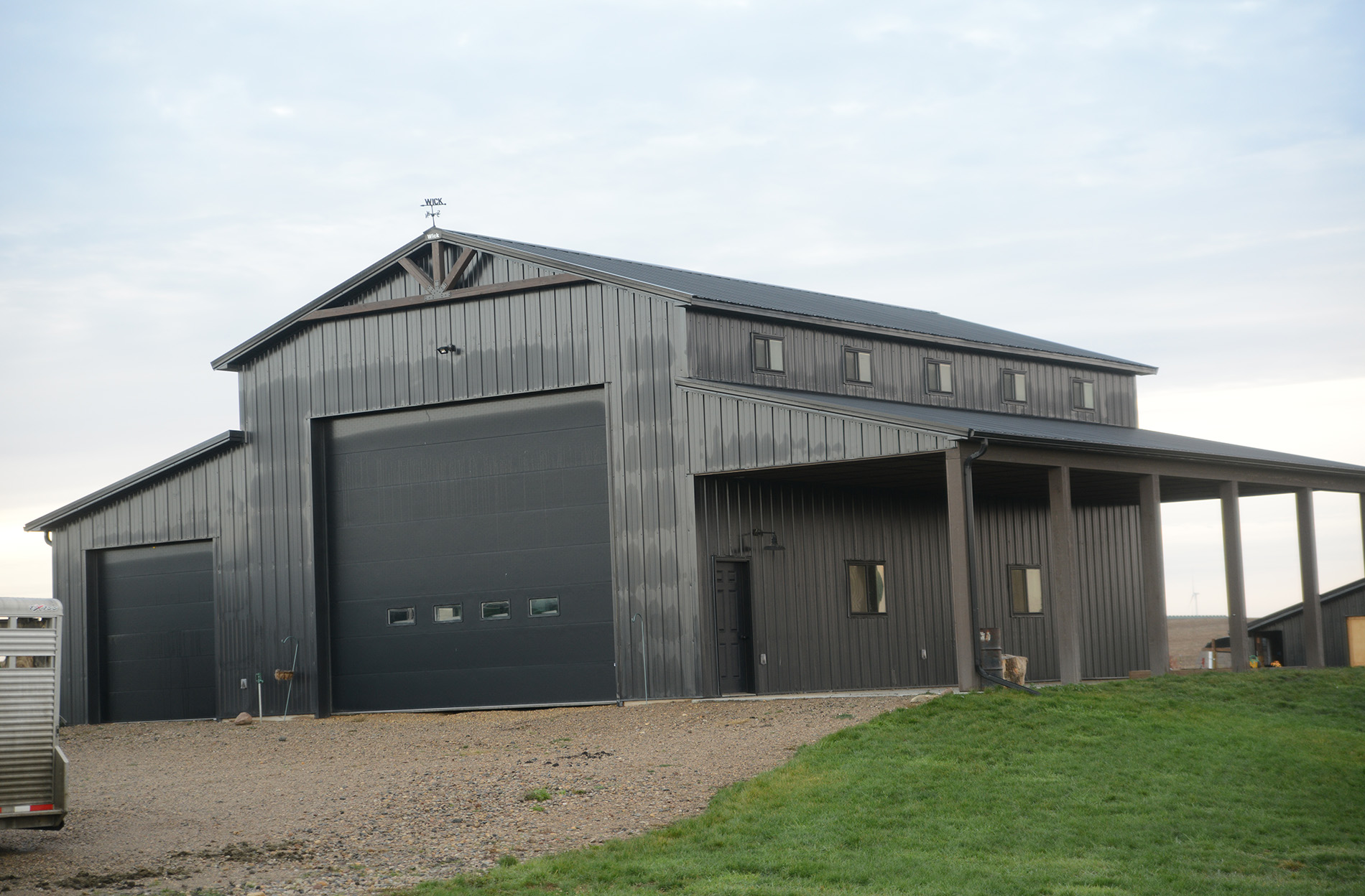 dark gray post frame suburban building